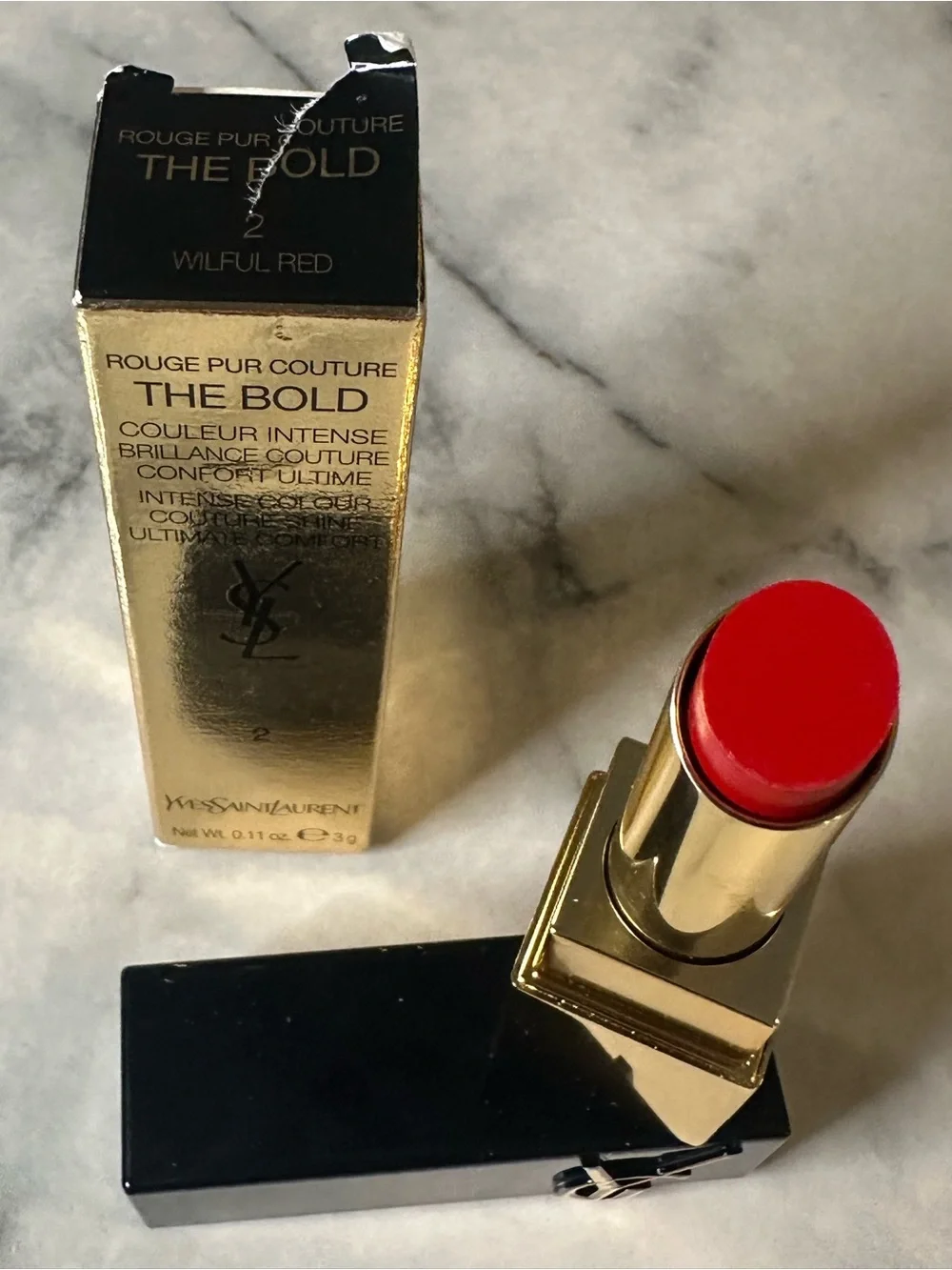 Yves Saint Laurent Gold & Black Tube Lipstick — Bright Red color “Wilful Red.”